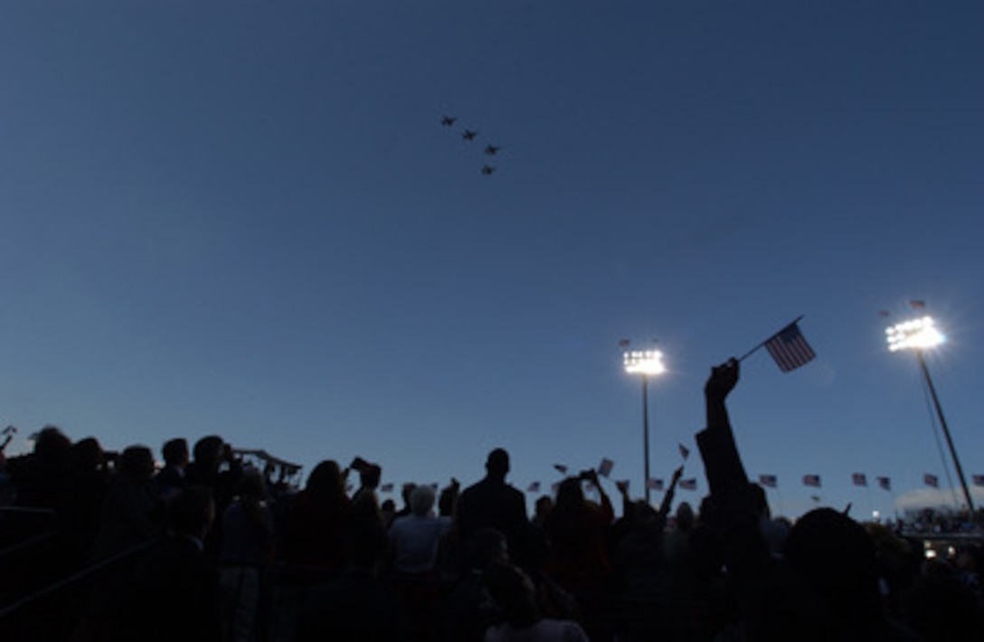 U.S. Air Force F-16 fighter jets fly over the Sept. 11 Memorial Service at the Pentagon. More than 13,000 people attended the service to remember those who lost their lives one year ago when terrorists crashed a commercial airliner into the Pentagon. 