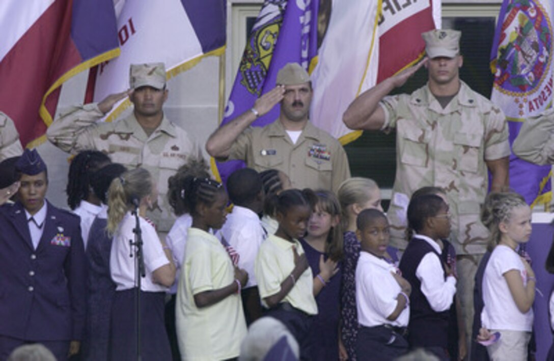 Children from local elementary and middle schools lead the reciting of the Pledge of Allegiance at the Sept. 11 Observance Ceremony at the Pentagon. More than 13,000 people attended the service to remember those who lost their lives one year ago when terrorists crashed a commercial airliner into the Pentagon. 