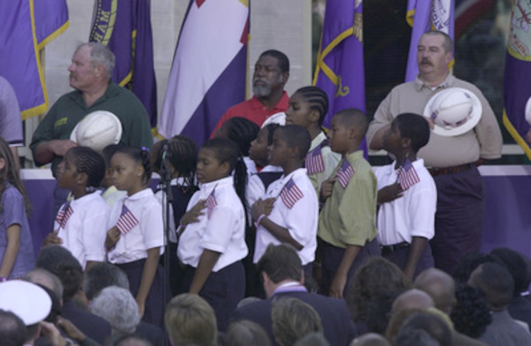 Children from local elementary and middle schools lead the reciting of the Pledge of Allegiance at the Sept. 11 Observance Ceremony at the Pentagon. More than 13,000 people attended the service to remember those who lost their lives one year ago when terrorists crashed a commercial airliner into the Pentagon. 