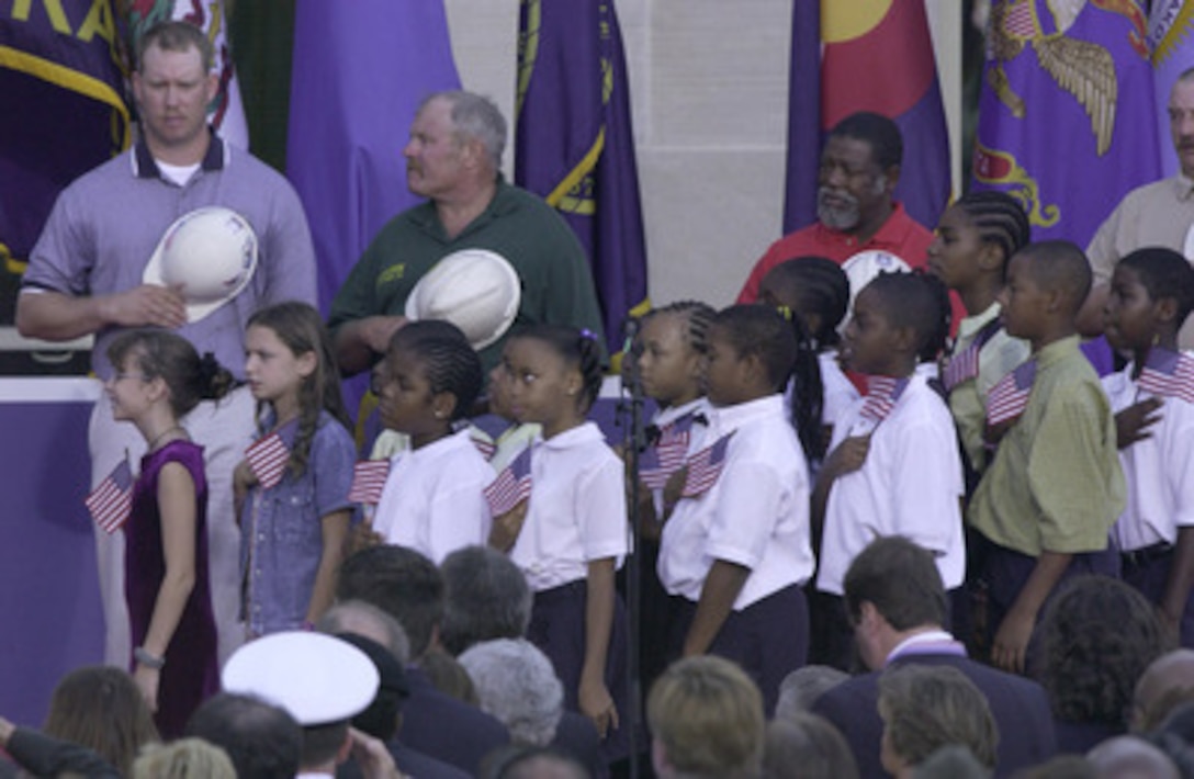 Members of the audience recite "The Pledge of Allegiance" during the Sept. 11 Observance Ceremony at the Pentagon. More than 13,000 people attended the service to remember those who lost their lives one year ago when terrorists crashed a commercial airliner into the Department of Defense headquarters. 