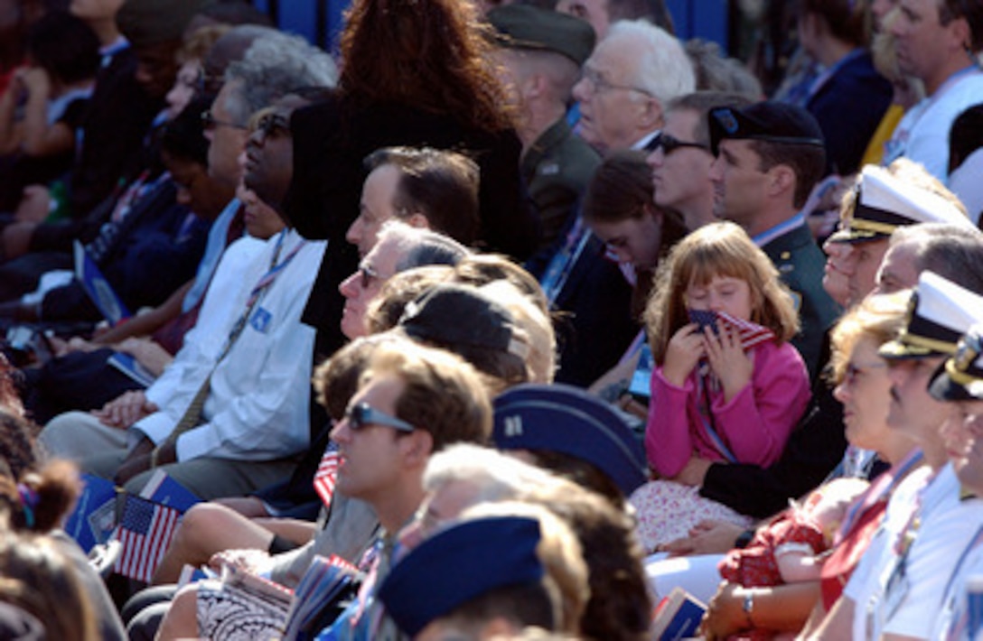 Members of the audience listen carefully during the Sept. 11 Observance Ceremony at the Pentagon. More than 13,000 people attended the service to remember those who lost their lives one year ago when terrorists crashed a commercial airliner into the Pentagon. 