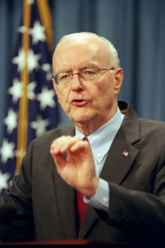 Under Secretary of the Air Force Peter Teets briefs Pentagon reporters on Sept. 3, 2002, about the opening of the Transformational Communications Office. The mission of the office is to ensure communications compatibility across the Department of Defense, the intelligence community and NASA. 