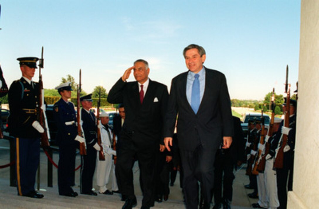 Minister of Foreign Affairs Yashwant Sinha of India is escorted into the Pentagon by Deputy Secretary of Defense Paul D. Wolfowitz on Sept. 9, 2002. The two leaders are meeting to discuss issues of mutual interest. 