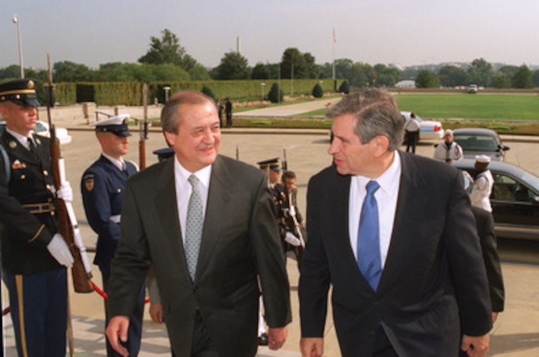 Deputy Secretary of Defense Paul Wolfowitz (right) escorts Uzbekistan's Minister of Foreign Affairs Abdulaziz Kamilov through an honor cordon and into the Pentagon on Sept. 17, 2002. The two men met to discuss a variety of regional security issues. 