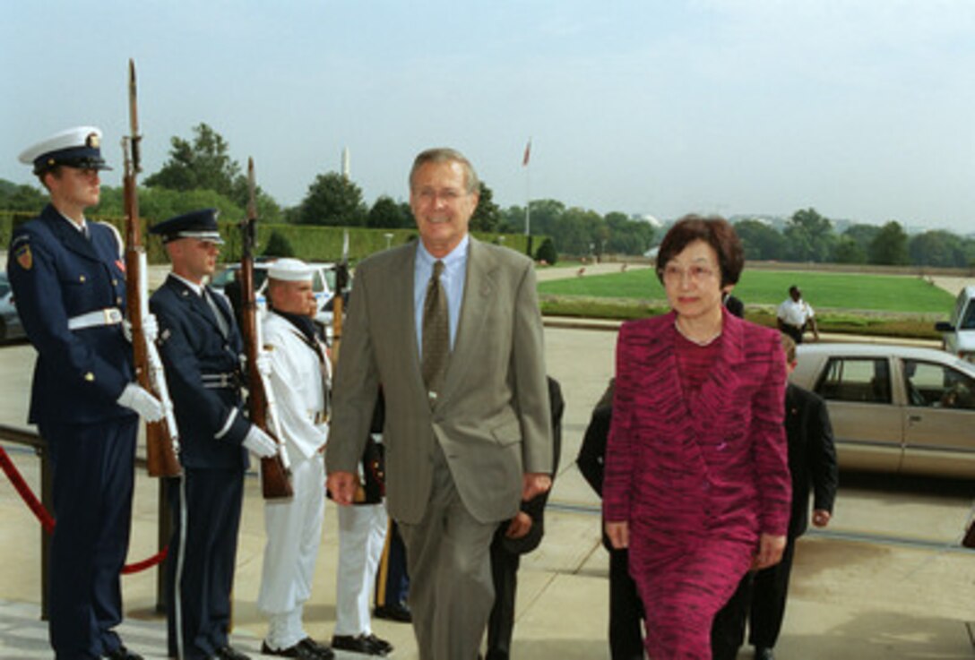 Secretary of Defense Donald H. Rumsfeld (left) escorts Japanese Minister of Foreign Affairs Yoriko Kawaguchi into the Pentagon on Sept. 16, 2002. The two leaders met to discuss defense issues of mutual concern. 