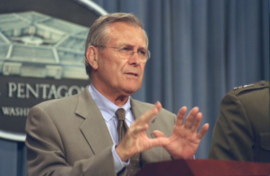 Secretary of Defense Donald H. Rumsfeld responds to a reporter's question as he and Marine Corps Gen. Peter Pace, vice chairman of the Joint Chiefs of Staff, conduct a Pentagon news briefing Sept. 16, 2002. 