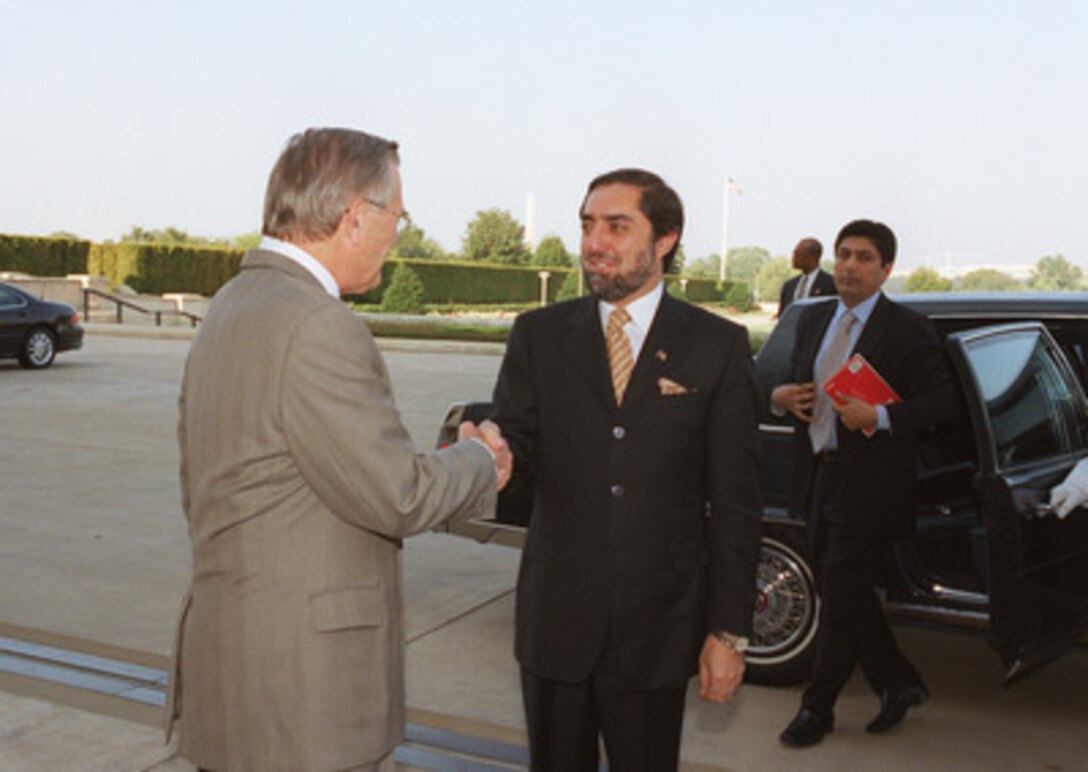 Afghan Foreign Minister Abdullah Abdullah (center) is greeted by Secretary of Defense Donald H. Rumsfeld as he arrives at the Pentagon Sept. 17, 2002. The two leaders will meet to discuss defense issues of mutual interest. 