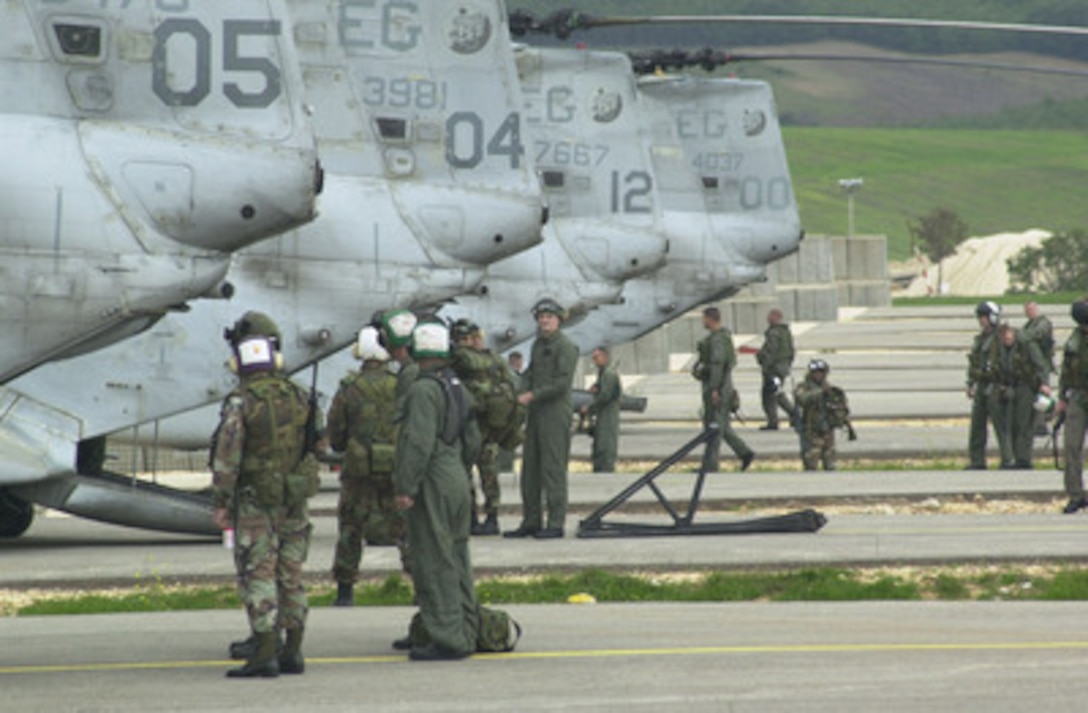 Marines from Marine Medium Helicopter Squadron 263, part of the 24th Marine Expeditionary Unit (Special Operations Capable), conduct post flight procedures on four CH-46 Sea Knight helicopters on Sept. 16, 2002, on the airfield at Camp Bondsteel, Kosovo. The MEU team is in Kosovo for a month, augmenting the peacekeeping mission, titled Dynamic Response, which is designed to demonstrate KFOR's ability to rapidly deploy troops to the region. 