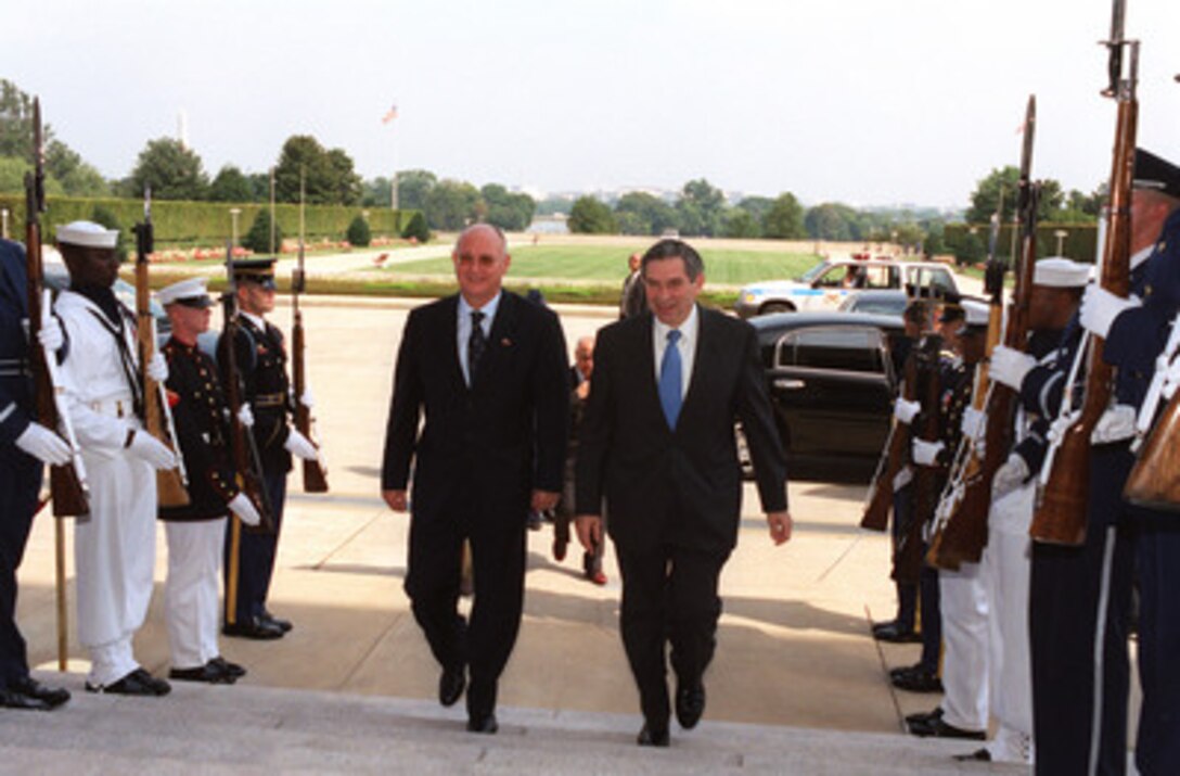 Minister of Defense of Romania Ioan Mircea Pascu (left) is escorted through an honor cordon and into the Pentagon by Deputy Secretary of Defense Paul D. Wolfowitz on Sept. 18, 2002. The two leaders are meeting to discuss defense issues of mutual interest. 