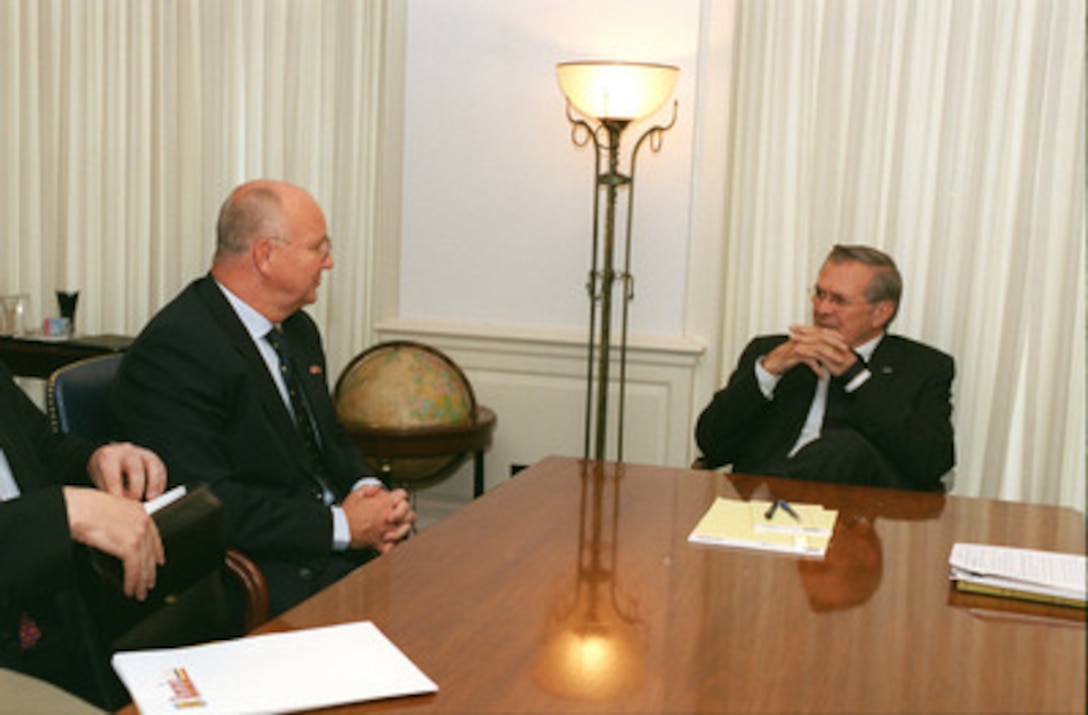 Minister of Defense of Romania Ioan Mircea Pascu (left) meets with Secretary of Defense Donald H. Rumsfeld in the Pentagon on Sept. 18, 2002. Rumsfeld and Pascu are meeting to discuss defense issues of mutual interest. 