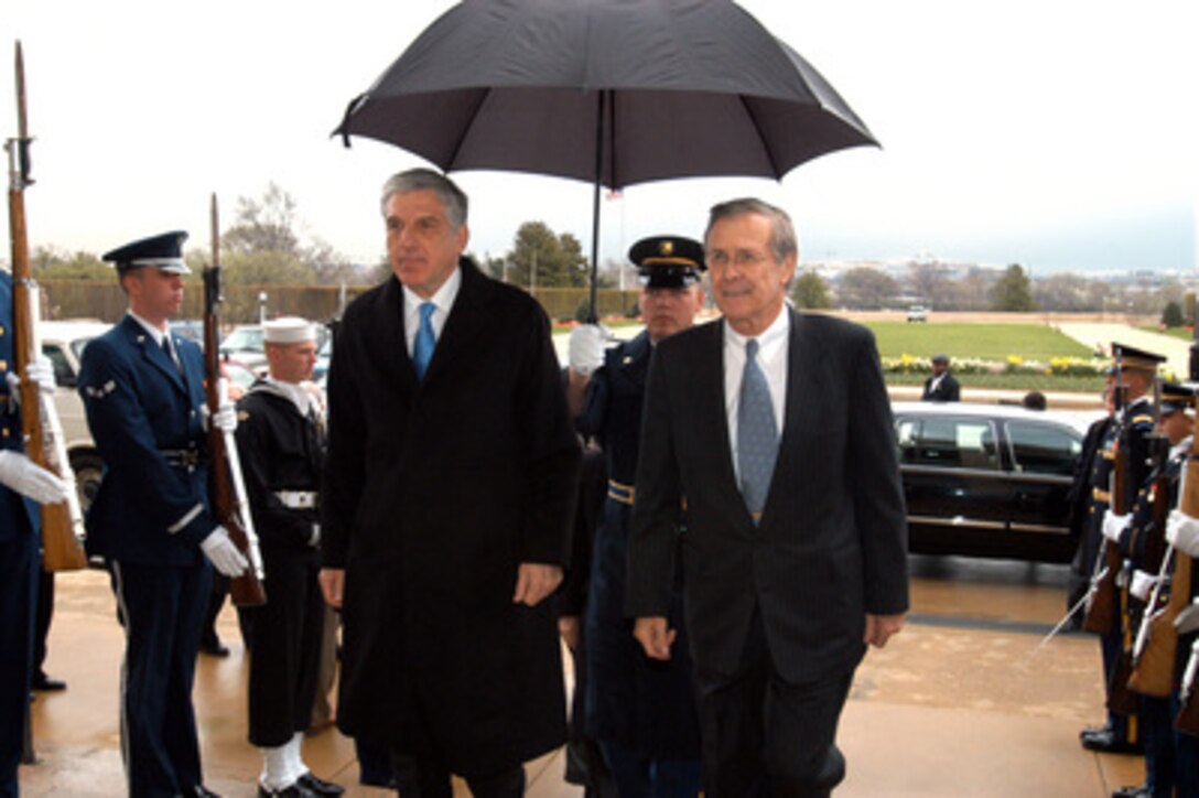 Secretary of Defense Donald H. Rumsfeld (right) escorts Greek Minister of National Defense Yannos Papantoniou through an honor cordon and into the Pentagon on April 1, 2003. The two defense leaders will meet to discuss a range of bilateral security issues. 