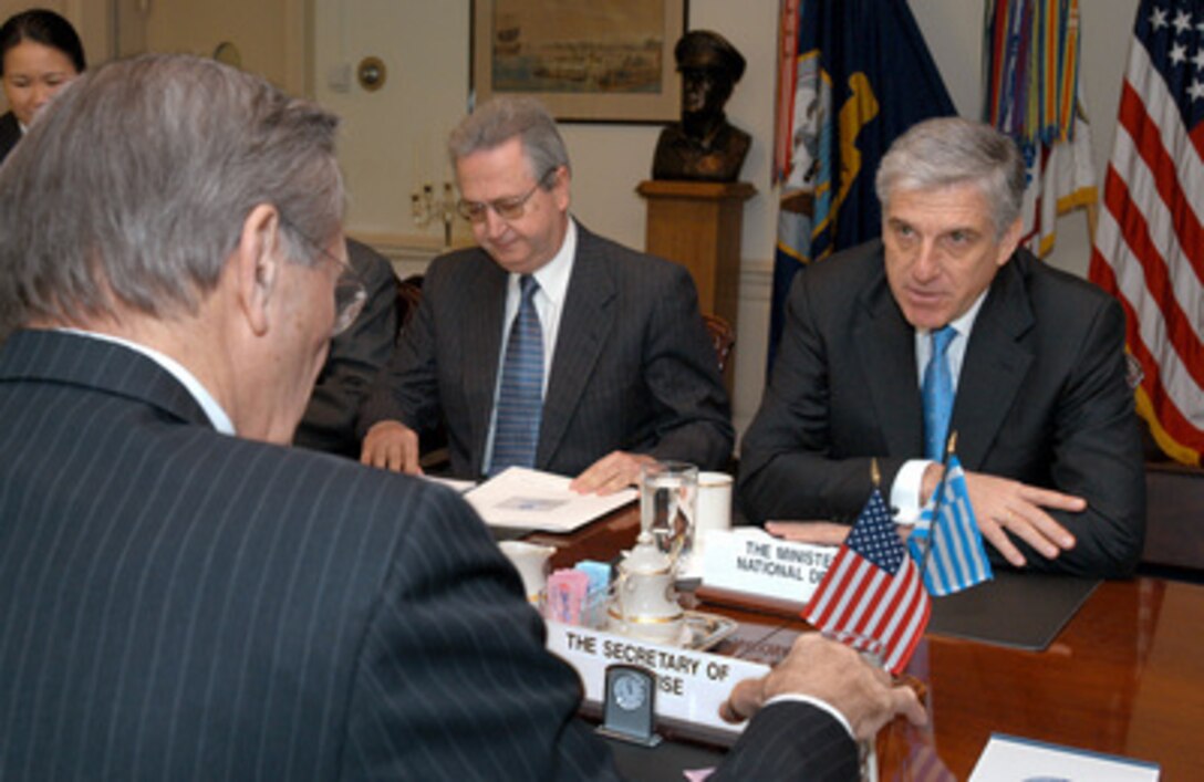 Greek Minister of National Defense Yannos Papantoniou (right) meets with Secretary of Defense Donald H. Rumsfeld (foreground) in the Pentagon on April 1, 2003. The two defense leaders are meeting to discuss a range of security issues of interest to both nations. Greece's Ambassador to the United States George Savvaides (center) joined Papantoniou and Rumsfeld for the talks. 