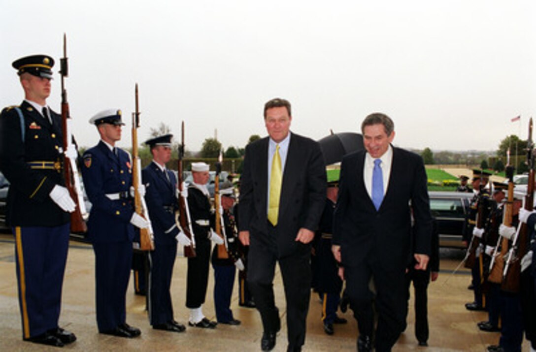 Deputy Secretary of Defense Paul Wolfowitz (right) escorts Australian Minister of Foreign Affairs Alexander Downer through an honor cordon and into the Pentagon on April 1, 2003. Wolfowitz and Downer will meet to discuss security issues of interest to both nations. 
