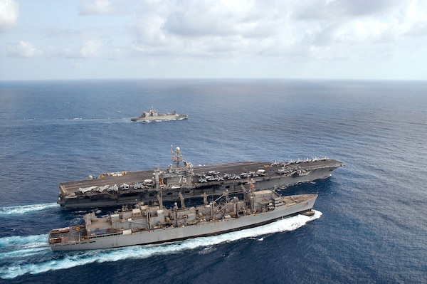 The nuclear powered aircraft carrier USS Harry S. Truman (CVN 75) conducts a refueling at sea (RAS) with the Military Sealift Command (MSC) fast combat support ship USNS Arctic (T-AOE 8) while simultaneously conducting a vertical replenishment (VERTREP) with the ammunition ship USNS Mount Baker (T-AE 34). Harry S. Truman and Carrier Airwing Three (CVW-3) are currently on a regularly scheduled deployment in support of Operation Iraqi Freedom.  Operation Iraqi Freedom is the multinational coalition effort to liberate the Iraqi people, eliminate Iraq's weapons of mass destruction and end the regime of Saddam Hussein.