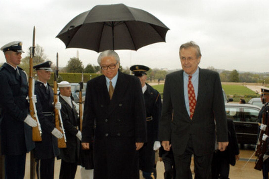 Secretary of Defense Donald H. Rumsfeld escorts Singapore's Minister of Defense Tony Tan through an honor cordon and into the Pentagon on April 11, 2003. Rumsfeld and Tan will meet to discuss national and international security items of interest to both nations. 