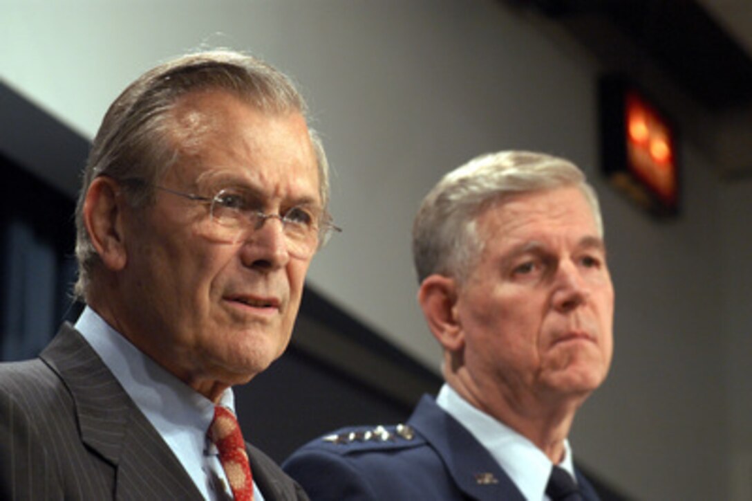 Secretary of Defense Donald H. Rumsfeld and Chairman of the Joint Chiefs of Staff Gen. Richard B. Myers, U.S. Air Force, listen to a reporter's question about looting in Baghdad during a Pentagon press conference on April 11, 2003. Rumsfeld and Myers briefed reporters on the progress of Operation Iraqi Freedom, which is the multinational coalition effort to liberate the Iraqi people, eliminate Iraq's weapons of mass destruction and end the regime of Saddam Hussein. 