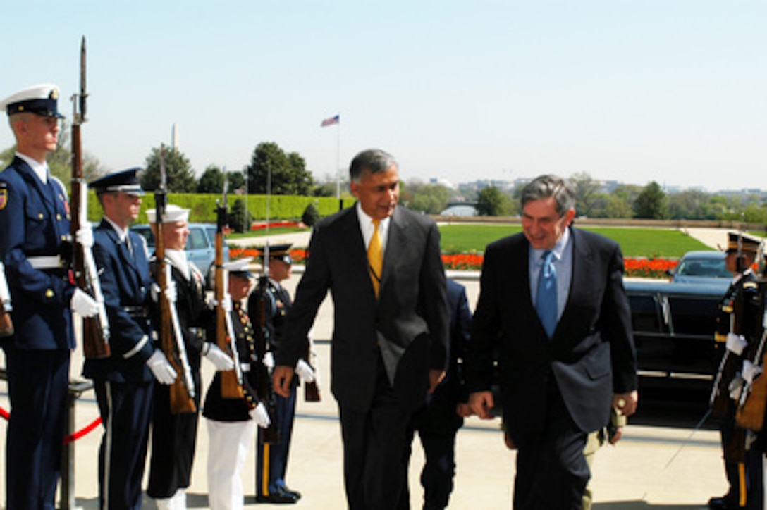 Deputy Secretary of Defense Paul Wolfowitz (right) escorts Pakistani Minister of Finance Shaukat Aziz through an honor cordon and into the Pentagon on April 15, 2003. Wolfowitz and Aziz will meet to discuss regional items of interest to both nations. 