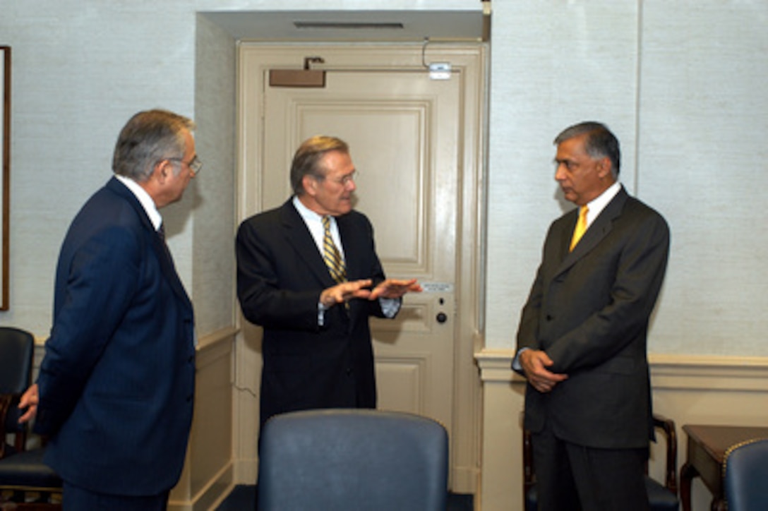 Secretary of Defense Donald H. Rumsfeld (center) talks to Pakistan's Minister of Finance Shaukat Aziz (right) and Ambassador to the U.S. Ashraf Jehangir Qazi (left) in the Pentagon on April 15, 2003. Rumsfeld stopped by Aziz and Qazi's meeting with Deputy Secretary of Defense Paul Wolfowitz to talk briefly with the Pakistani diplomats. 