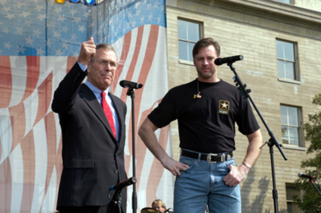 Secretary of Defense Donald H. Rumsfeld tells the audience about Nashville singer/songwriter Darryl Worley prior to a concert in the center courtyard of the Pentagon on April 16, 2003. One of the songs Worley sang for the military and DoD employee audience at the Pentagon and around the world on American Forces Radio and Television was his hit single "Have You Forgotten." Worley wrote the song after traveling with the United Service Organizations to entertain troops in Afghanistan last December. 
