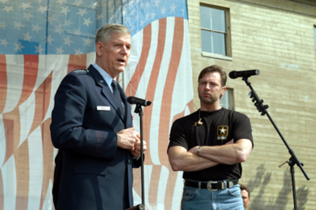 Chairman of the Joint Chiefs of Staff Gen. Richard B. Myers, U.S. Air Force, talks about Nashville singer/songwriter Darryl Worley prior to a concert in the center courtyard of the Pentagon on April 16, 2003. One of the songs Worley sang for the military and DoD employee audience at the Pentagon and around the world on American Forces Radio and Television was his hit single "Have You Forgotten." Worley wrote the song after traveling with the United Service Organizations to entertain troops in Afghanistan last December. 