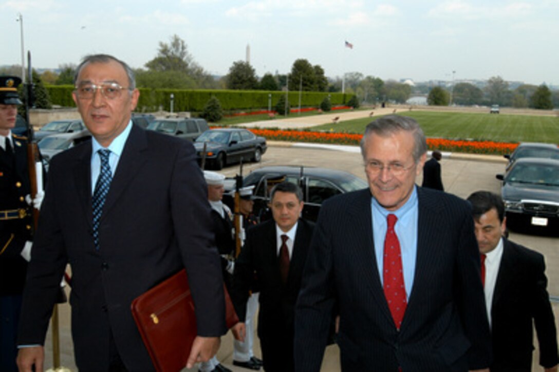 Secretary of Defense Donald H. Rumsfeld (right) escorts Uzbekistan's Minister of Defense Kodir Ghulomov into the Pentagon on April 16, 2003. Rumsfeld, Ghulomov and other senior officials of both nations will meet to discuss a range of bilateral security issues. 