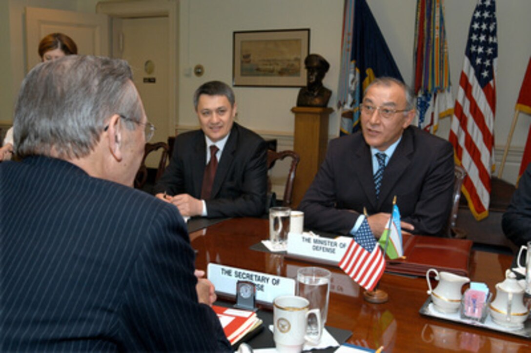 Uzbekistan's Minister of Defense Kodir Ghulomov (right) meets with Secretary of Defense Donald H. Rumsfeld (foreground) in the Pentagon on April 16, 2003. Ghulomov, Rumsfeld and other senior officials of both nations are meeting to discuss a range of bilateral security issues. Uzbekistan's Deputy Prime Minister and Minister of Economics Rustam Azimov joined the two defense leaders in the talks. 