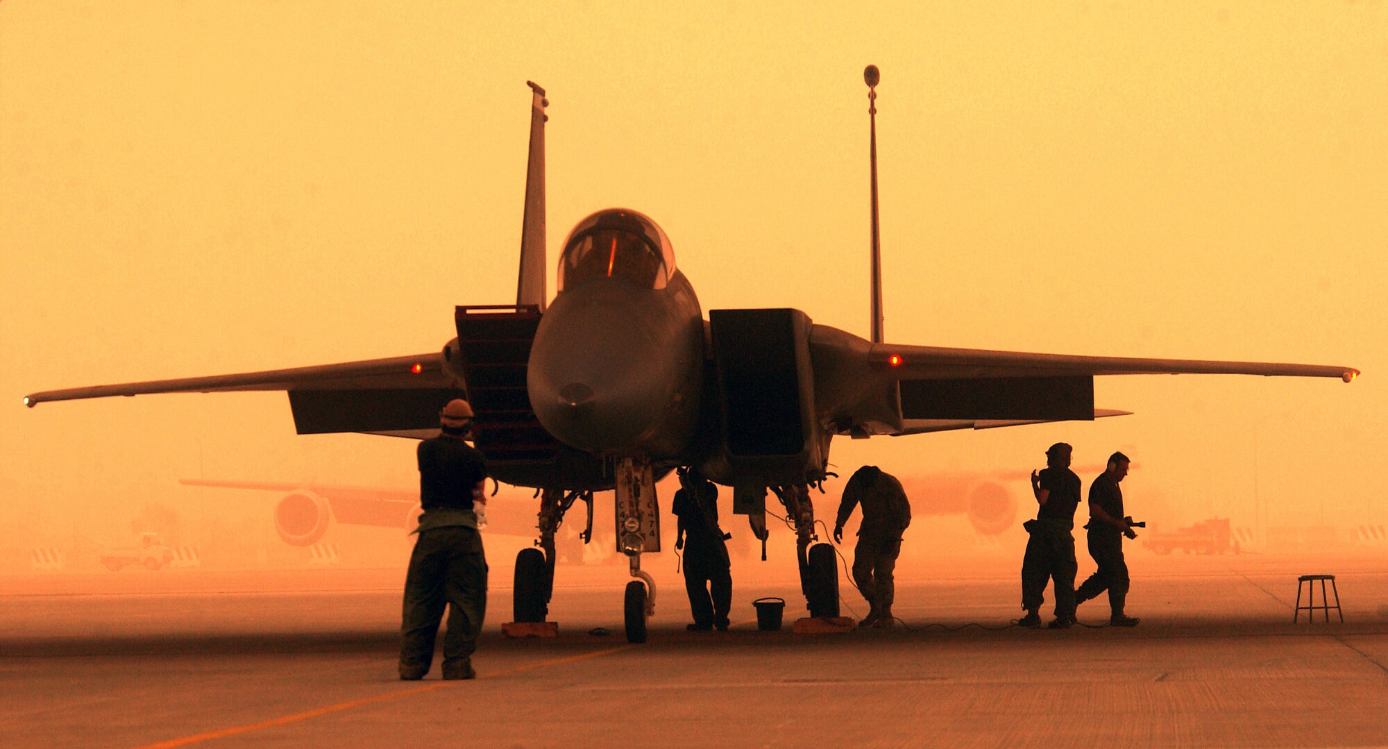 OPERATION IRAQI FREEDOM -- Air Force maintainers prepare to launch an F-15C Eagle for a strike misison from a forward deployed Operation Iraqi Freedom location.  The maintenance technicians are assigned to the 363rd Expeditionary Maintenance Squadron.  Coalition aircraft flew more than 1,500 sorties March 26 supporting Operation Iraqi Freedom.  (U.S. Air Force Photo by Staff Sgt. Matthew Hannen)