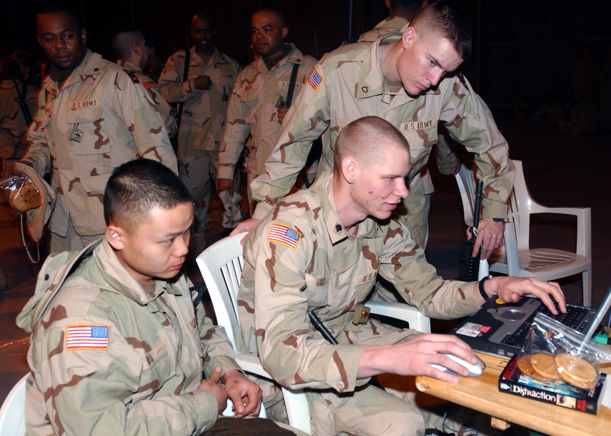 AVIANO AIR BASE, Italy -- Army soldiers from Fort Lee, Va., play a computer game while on a layover here awaiting transportation to a forward-deployed location. (U.S. Air Force photo by Airman 1st Class Nichole Adamowicz)