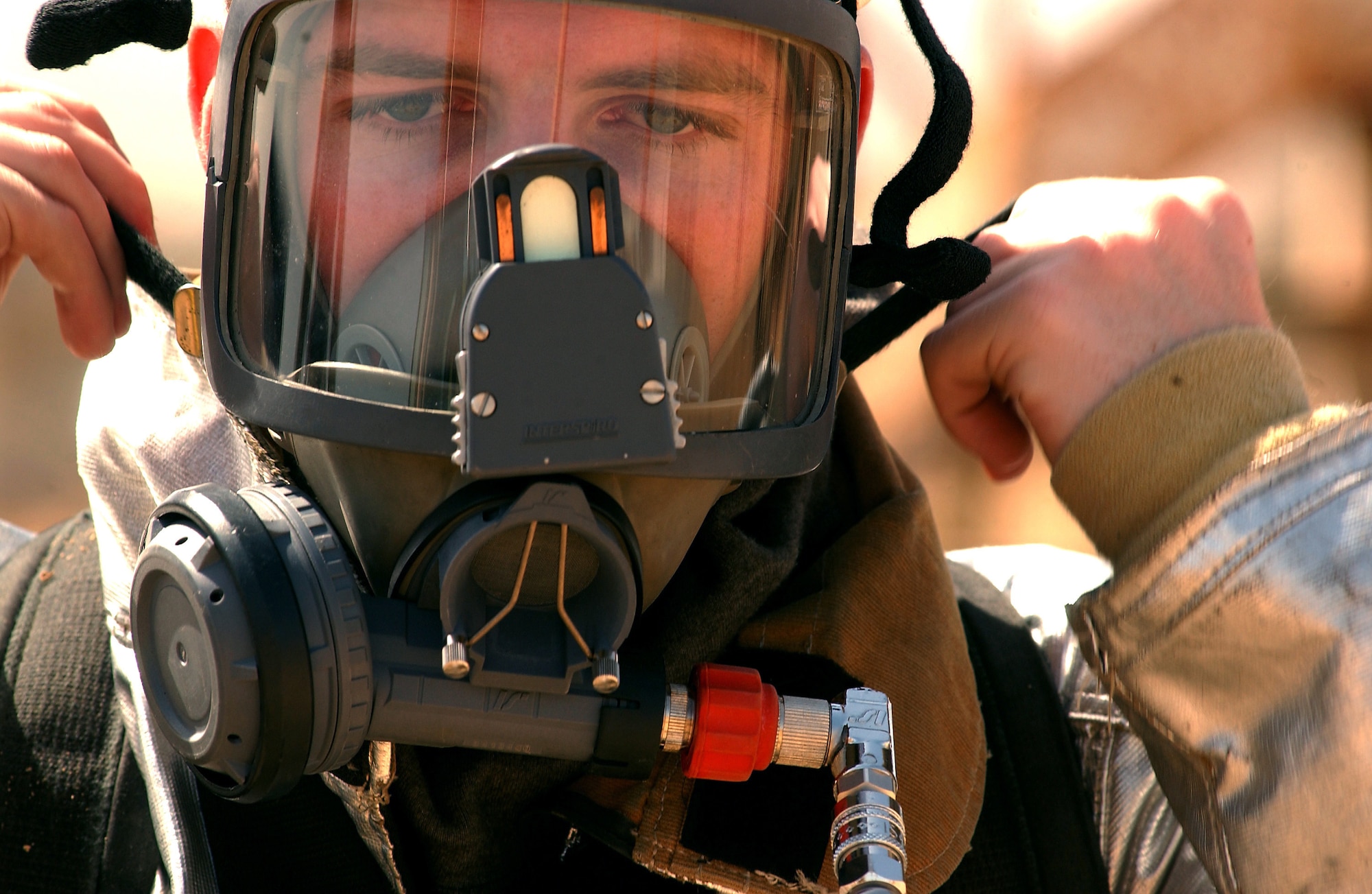 OPERATION ENDURING FREEDOM  --  Senior Airman Michael Campbell checks for a seal on his oxygen mask during a joint fire rescue exercise at an Enduring Freedom forward deployed locaiton.  Campbell is a firefighter with the 320th Expeditionairy Civil Engineering Squadron.  (U.S. Air Force photo by Staff Sgt. Matthew Hannen)