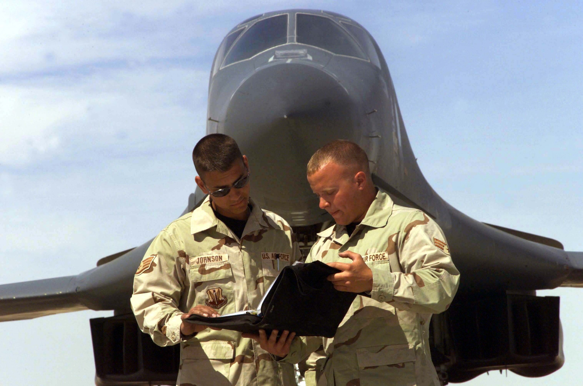SOUTHWEST ASIA -- Staff Sgt. Andrew Johnson (left) and Senior Airman Nicholas Guthmiller review a maintenance checklist on a B-1 Lancer at a forwarded-deployed location in Southwest Asia.  Both airmen are crew chiefs with the 28th Expeditionary Aircraft Maintenance Squadron.  (U.S. Air Force photo by Senior Airman Tia C. Schroeder)