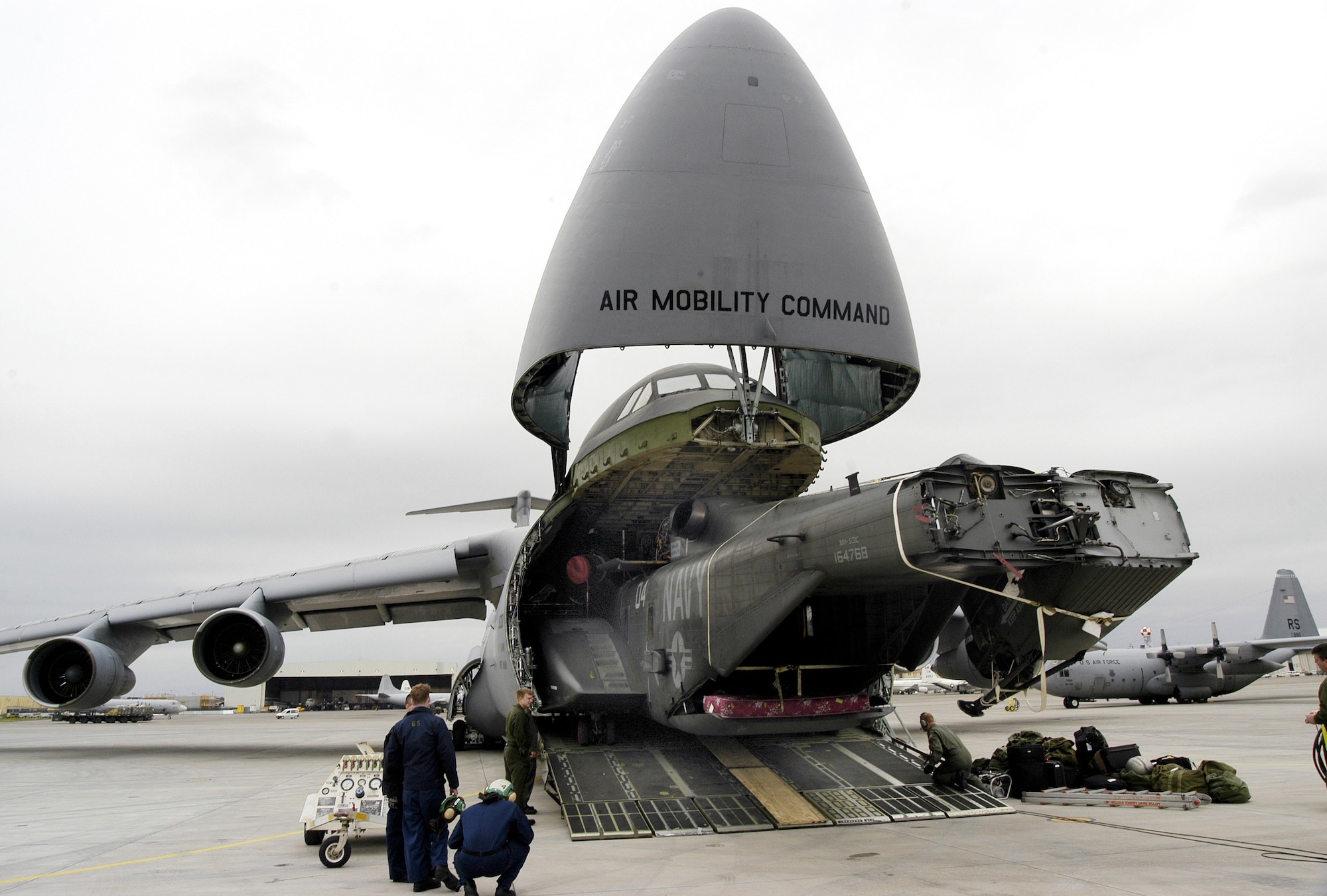 SIGONELLA NAVAL AIR STATION,  Sicily -- A Navy MH-53E Sea Dragon is unloaded from a C-5 Galaxy here March 14.  (DOD photo by Petty Officer 2nd Class James K. McNeil)
