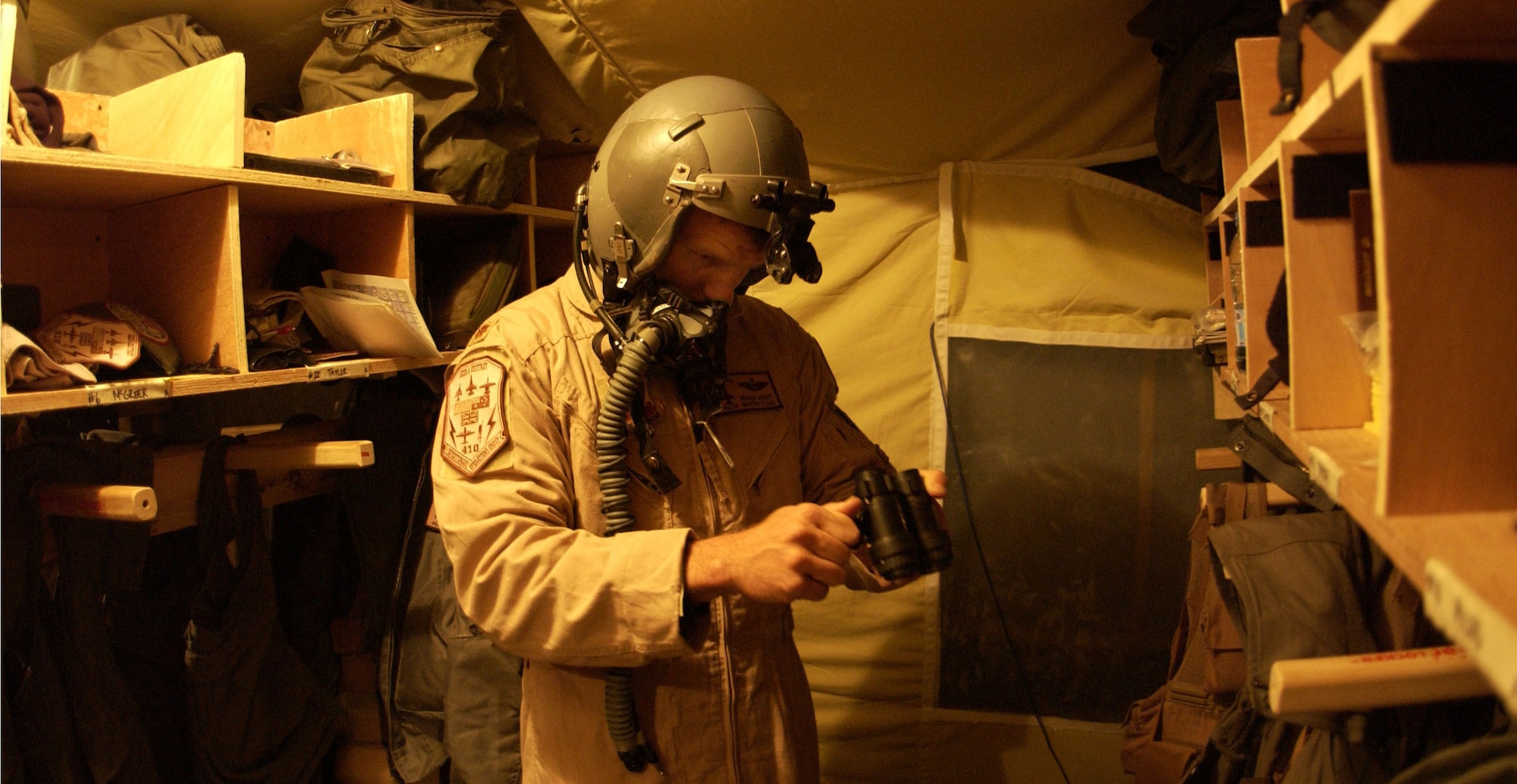 OPERATION IRAQI FREEDOM -- An F-16 Fighting Falcon pilot checks out his night vision goggles prior to a mission.  The airman is from the 410th Air Expeditionary Wing at a forward-deployed location supporting Operation Iraqi Freedom.  (U.S. Air Force photo by Staff Sgt. Bennie J. Davis III)