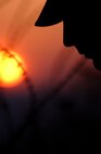 OSAN AIR BASE, South Korea -- Staff Sgt. Garrett Rosier from the 1st Combat Camera Squadron at Charleston Air Force Base, S.C., watches the sun set here March 19.  Members of the squadron deployed to Osan to cover an annual exercise. (U.S. Air Force photo by Staff Sgt. Stacy Pearsall)