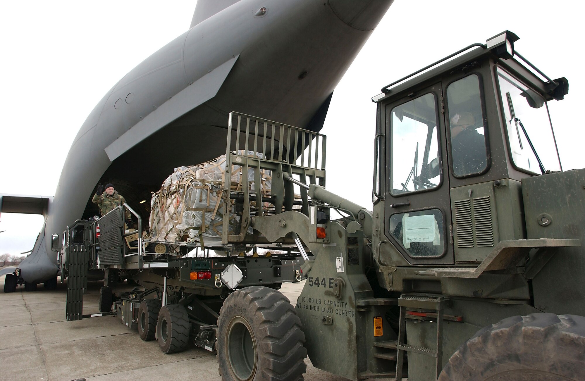 CONSTANTA, Romania - Airmen from the 349th Tanker Airlift Control Element unload a C-17 Globemaster III from McChord Air Force Base, Wash. This base in Romania is a key link in the air bridge supporting Operation Iraqi Freedom. (U.S. Air Force photo by Master Sgt. Keith Reed)                      