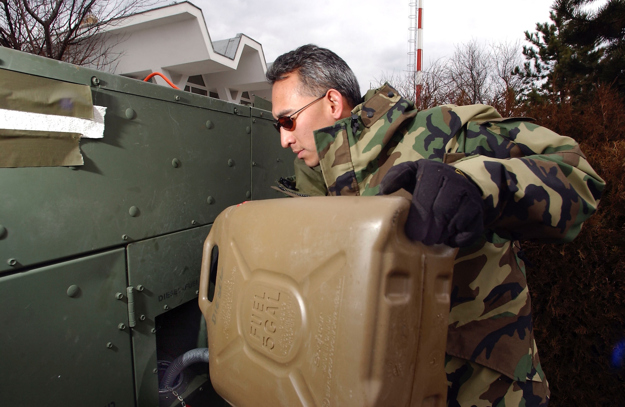 CONSTANTA, Romania -- Tech. Sgt. Jay Spencer refuels a generator that supplies power for communications and computers to the 54-person 349th Tanker Airlift Control Element here. The TALCE supports the Operation Iraqi Freedom air bridge.  Spencer is a communication and aerospace-ground-equipment specialist. (U.S. Air Force photo by Master Sgt. Keith Reed)                             