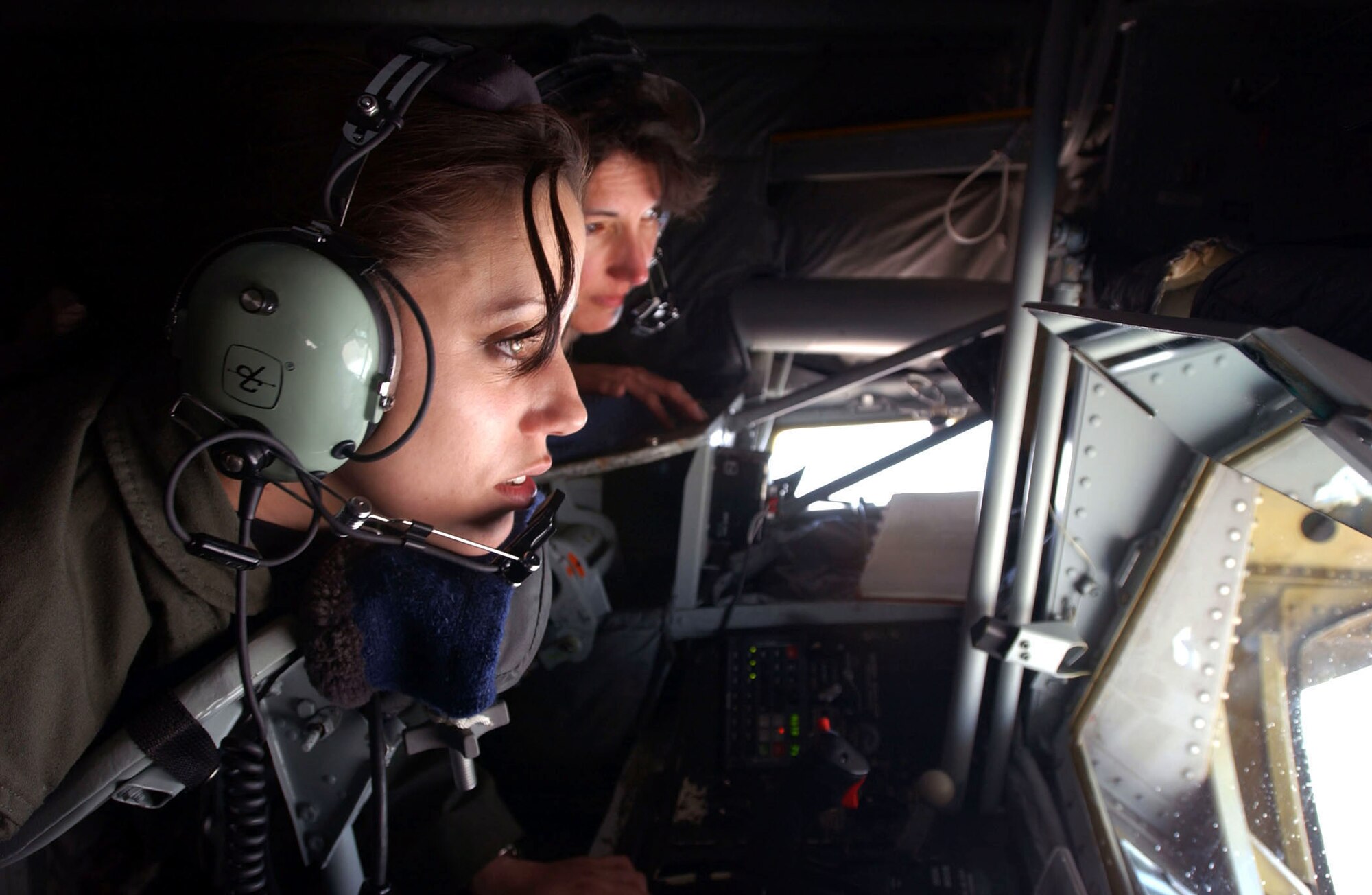SOUTHWEST ASIA --  Airman Edel Brooks (left), a boom operator from the 911th Air Refueling Squadron, Grand Forks Air Force Base, N.D., works with a "receiver" aircraft taking on fuel during a recent mission. Observing is Col. Cathy Clothier, 319th Operations Group commander. (U.S. Air Force photo by Master Sgt. Mark Bucher)     
