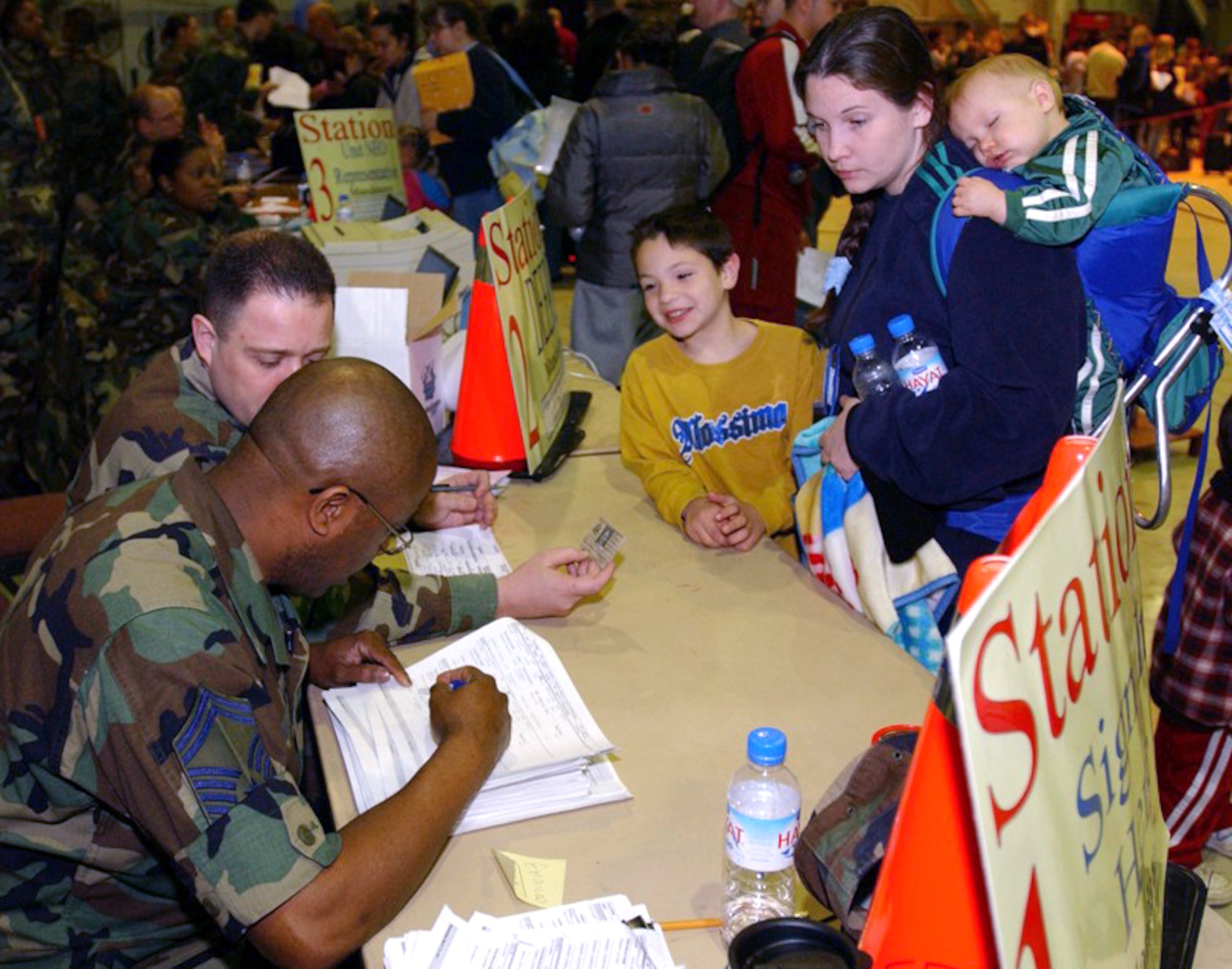 INCIRLIK AIR BASE, Turkey -- Family members of 39th Wing airmen go through a processing line March 19 as part of Incirlik's voluntary dependent relocation.  Representatives from various base agencies helped approximately 320 dependents leave the base.  The first aircraft left Incirlik at 4:30 p.m. March 20. (U.S. Air Force photo by Airman 1st Class Joseph Thompson)