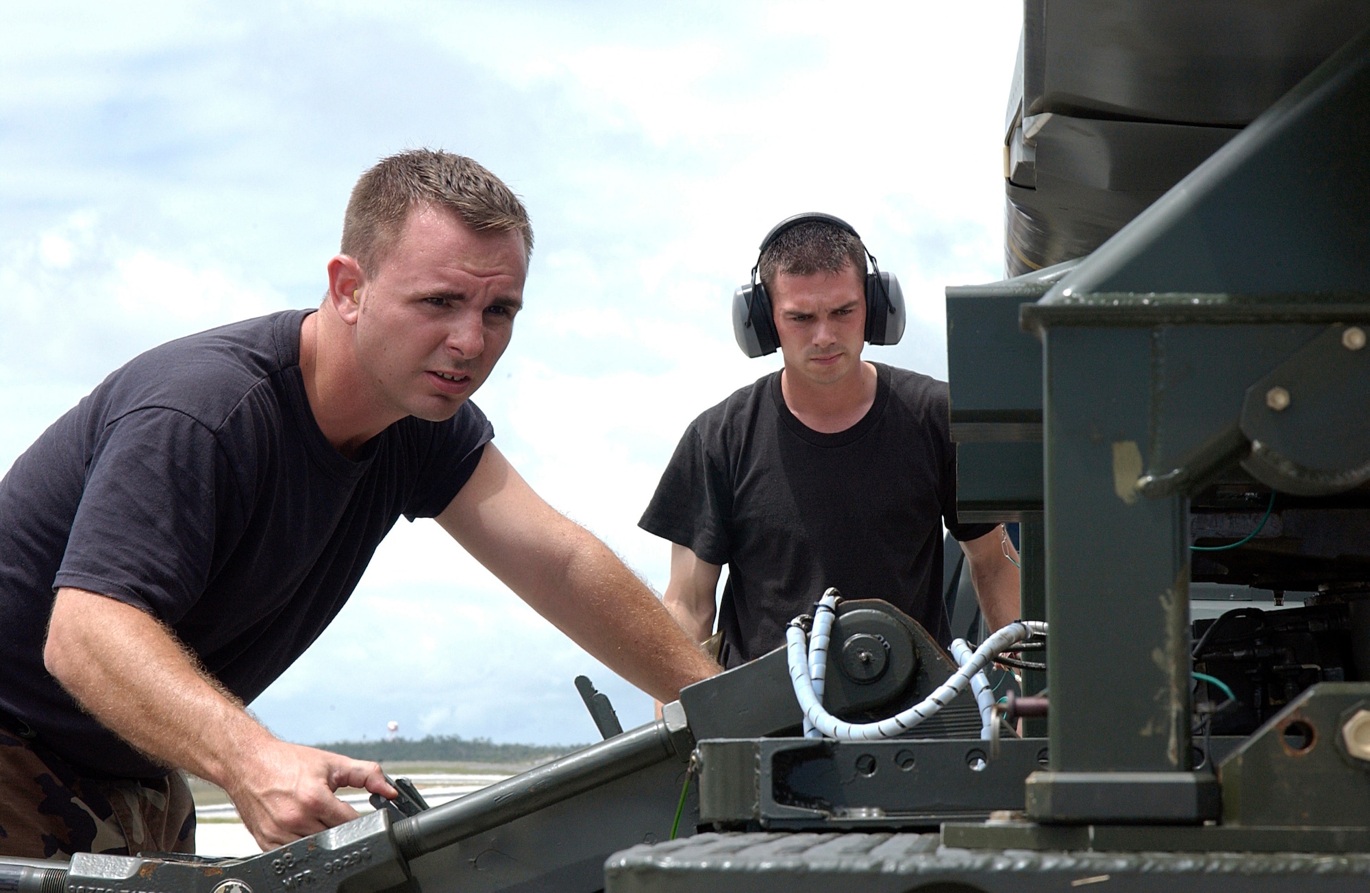 ANDERSEN AIR FORCE BASE, Guam  --  Staff Sgts. John Beldin and Landon Favors, B-52 Stratofortress weapons loaders, prepare an air-launched cruise missle for loading on a B-52 here March 20.  Aircraft and support troops from the 2nd Bomb Wing at Barksdale Air Force Base, La., are deployed as part of the 7th Air Expeditionary Wing.  (U.S. Air Force photo by Senior Airman Christina M. Rumsey)