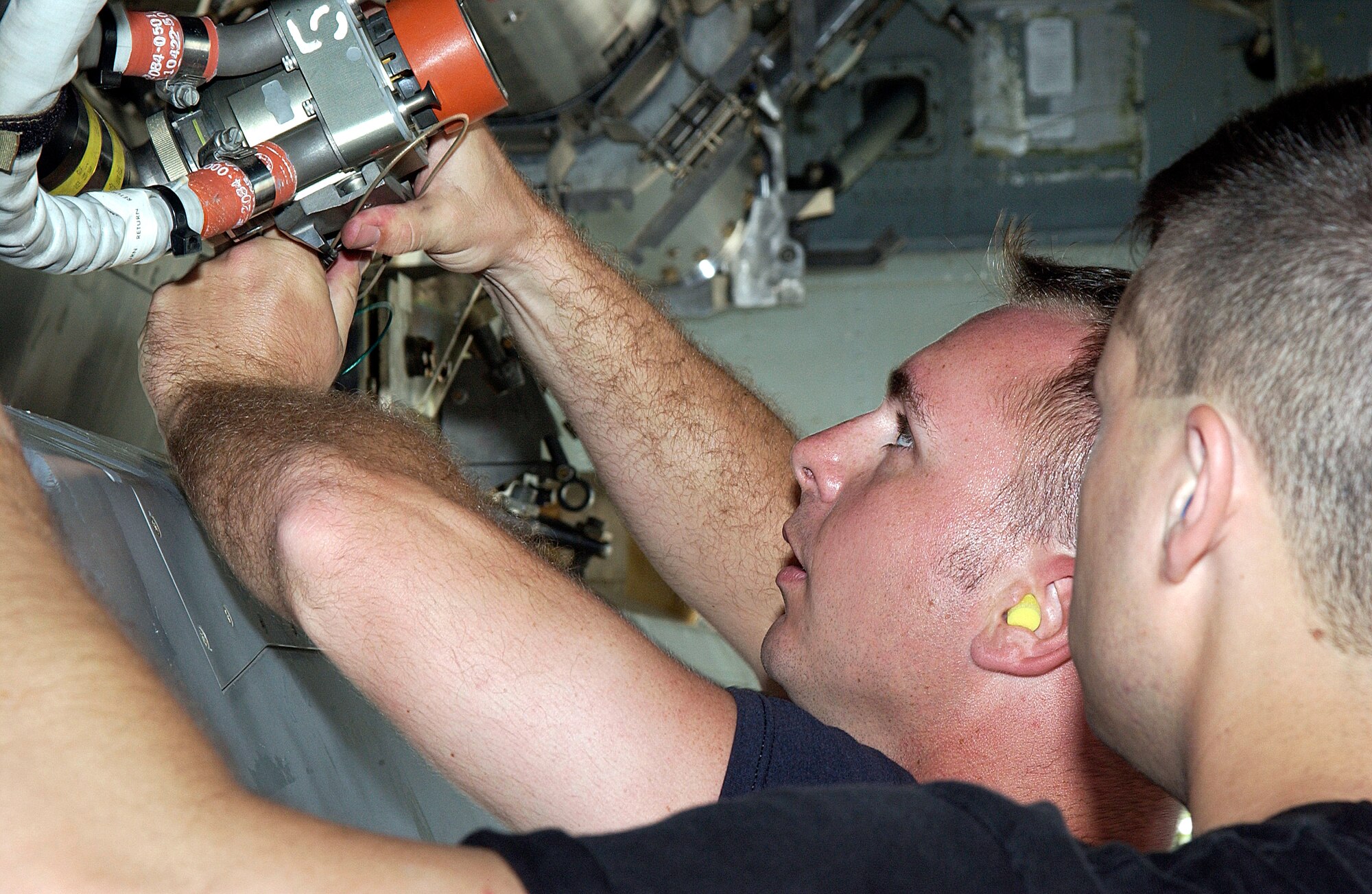 ANDERSEN AIR FORCE BASE, Guam  --  Staff Sgts. John Beldin and Landon Favors, B-52 Stratofortress weapons loaders, prepare an air-launched cruise missle for loading on a B-52 here March 20.  Aircraft and support troops from the 2nd Bomb Wing at Barksdale Air Force Base, La., are deployed as part of the 7th Air Expeditionary Wing.  (U.S. Air Force photo by Senior Airman Christina M. Rumsey)