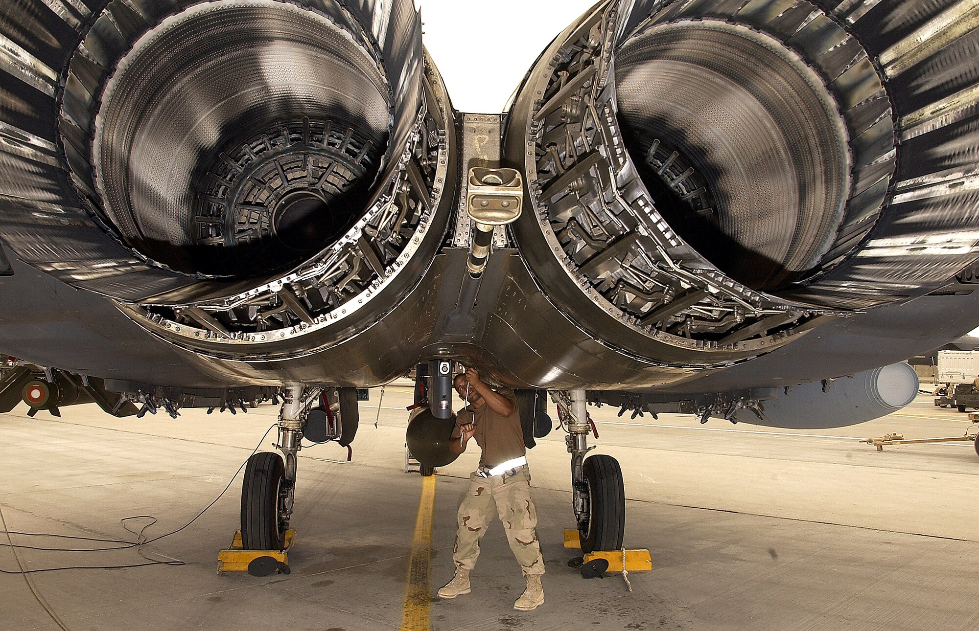 SOUTHWEST ASIA -- A crew chief from the 335th Expeditionary Fighter Squadron prepares an F-15E Strike Eagle for a mission at a forward-deployed location on March 21, 2003. The Strike Eagles from Seymour Johnson A.F.B., are deployed in support of current operations in the Middle East. (U.S. Air Force photo by Staff Sgt. Derrick C. Goode)