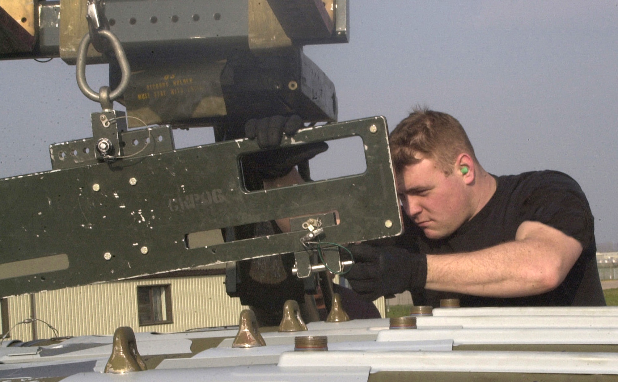 OPERATION IRAQI FREEDOM -- Senior Airman Daniel Murdock, weapons loader, prepares a GBU-31 Joint Direct Attack Munition.  Aircraft and people are deployed to this forward-deployed air base as part of the 457th Air Expeditionary Group.  (U.S. Air Force photo by Staff Sgt. Kristina Barrett)