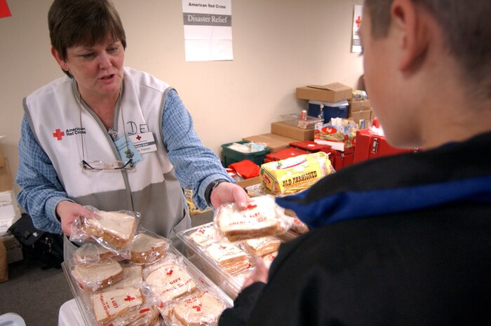 CHARLESTON AIR FORCE BASE, S.C. -- An American Red Cross Disaster Relief worker provides a sandwich to a former resident of Incirlik Air Base, Turkey. More than 1,300 Air Force family members and nonmission-essential civilian employees from the base arrived at Charleston International Airport, S.C., on March 21. (U.S. Air Force photo by Staff Sgt. Dominic Hauser)