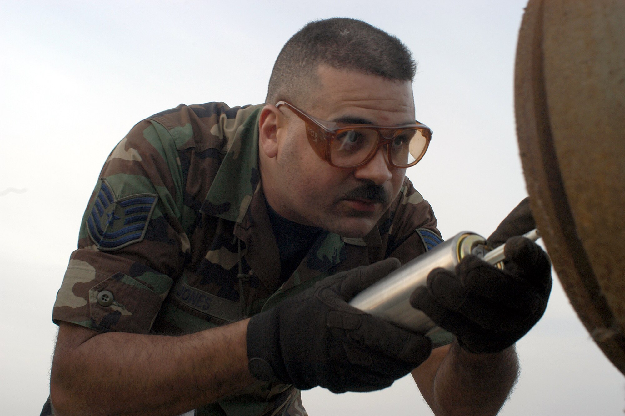 OPERATION IRAQI FREEDOM -- Tech. Sgt. Douglas Jones, munitions troop with the 5th Expeditionary Maintenance Squadron, loads a fuse into a GBU-31 joint direct attack munition. (U.S. Air Force photo by Staff Sgt. Kristina Barrett)