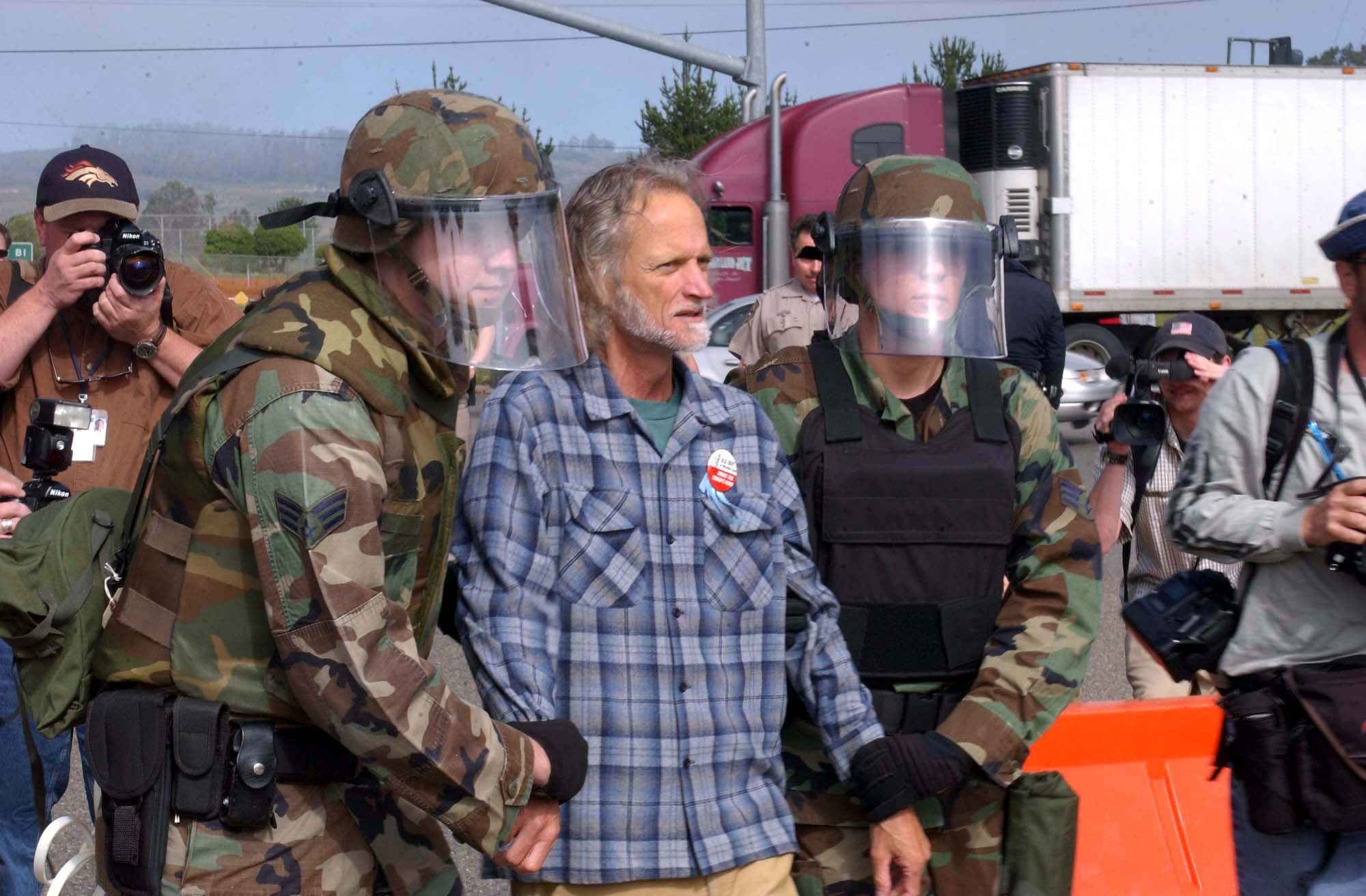 VANDENBERG AIR FORCE BASE, Calif. -- Vandenberg security forces apprehend Sanderson Beck March 22 at the base's Santa Maria Gate.  After crossing the green line onto Vandenberg property, Beck announced he is running for President of the United States.  Security forces gave him two minutes to leave the premises and when he refused, they aprehended him. (U.S. Air Force Photo by Staff Sgt. Quinton Russ)