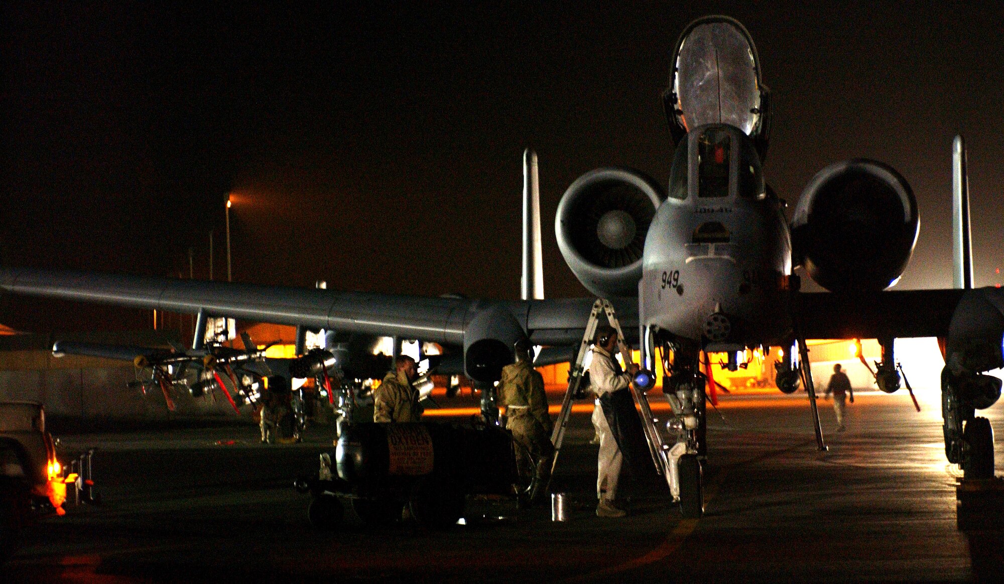 OPERATION IRAQI FREEDOM -- Maintenance troops work on an A-10 Thunderbolt II on March 23 at a forward-deployed Operation Iraqi Freedom location.   The tank-killing A-10 is affectionately known as the Warthog.  (U.S. Air Force photo by Senior Airman JoAnn S. Makinano)                          