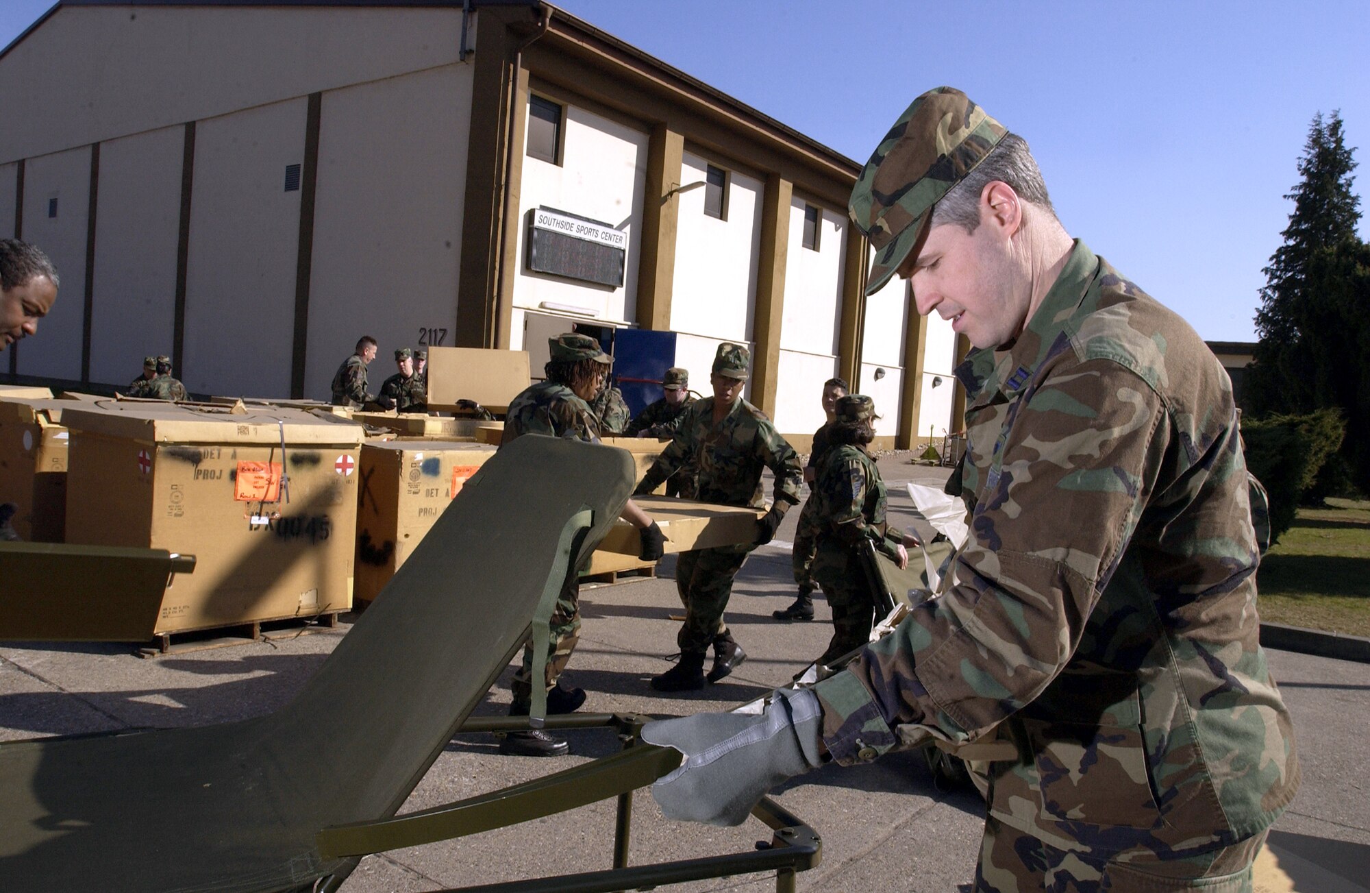 RAMSTEIN AIR BASE, Germany -- Reserve Capt. Sean Rowland, a certified registered nurse anesthetist with the 514th Air Evacuation Staging Squadron, McGuire Air Force Base, N.J., assembles one of many field litter beds that will be placed in Ramstein's southside gym. (U.S. Air Force photo by Tech. Sgt. Justin D. Pyle)                            