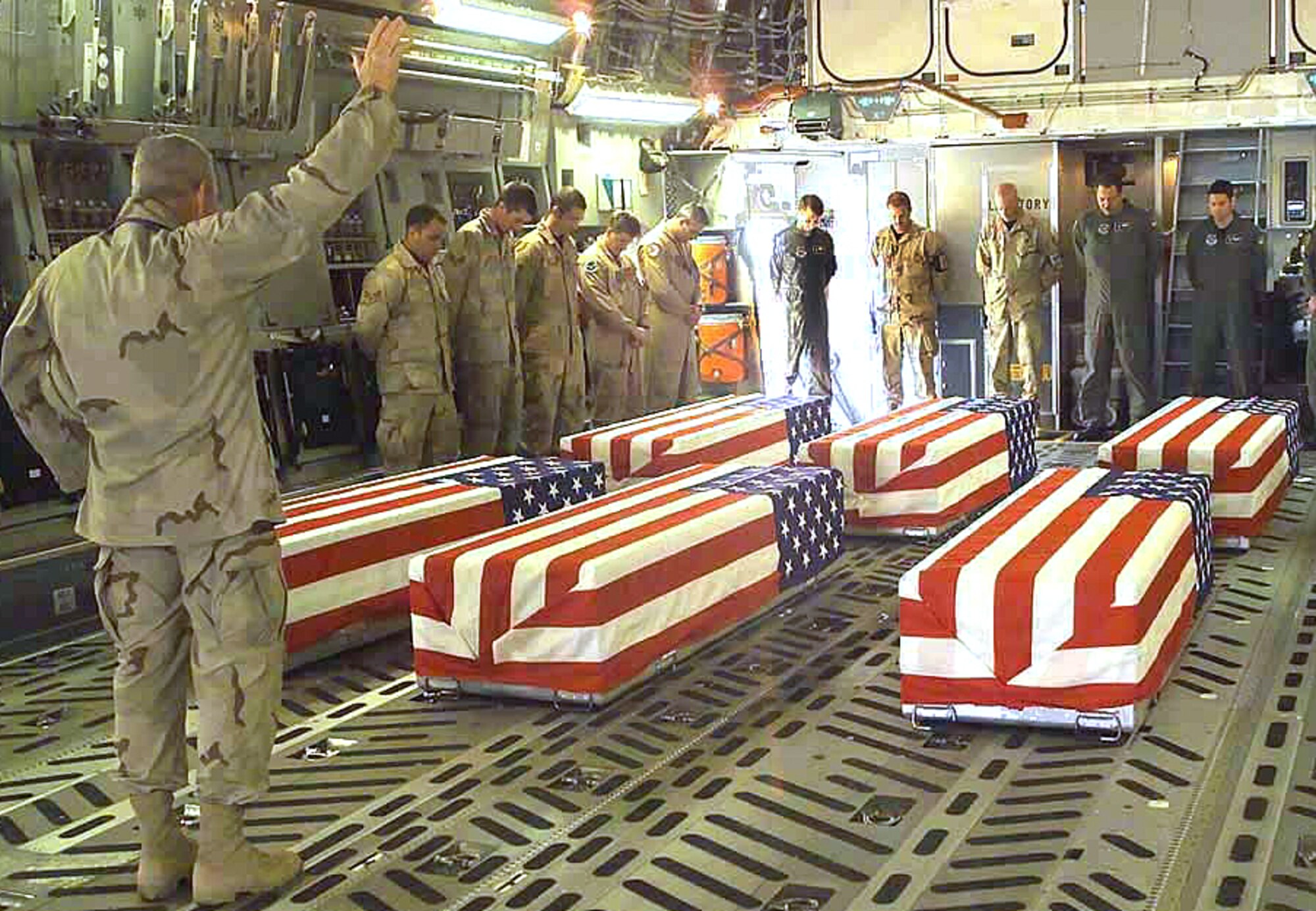 OPERATION ENDURING FREEDOM -- Army Chaplain (Col.) Richard Rogers performs last rites March 25 for six airmen killed when their HH-60G Pave Hawk helicopter crashed near Ghazni, Afghanistan, March 23.  The helicopter crew was on its way to pick up two Afghan children for treatment in U.S. medical facilities at Bagram Air Base.  The remains were being flown to Dover Air Force Base, Del.  The airmens’ names are being withheld pending notification of next of kin. (U.S. Army photo by Pvt. Terri Rorke)
