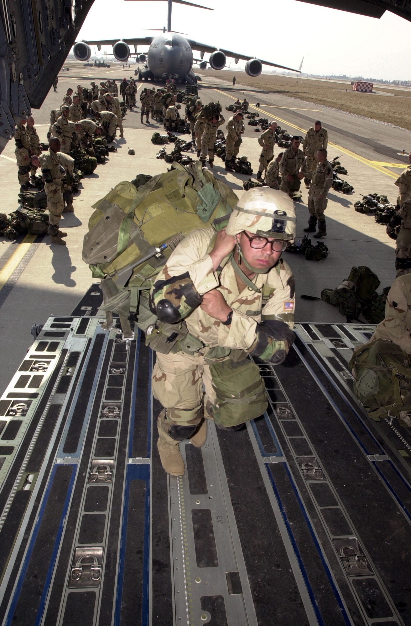 OPERATION IRAQI FREEDOM -- A soldier boards a C-17 Globemaster III.  Nearly 1,000 "Sky Soldiers" of the 173rd Airborne Brigade parachuted from C-17s into the Kurdish-controlled area of northern Iraq.  This was the first combat insertion of paratroopers using a C-17.  (U.S. Air Force photo by Airman 1st Class Isaac G. L. Freeman)