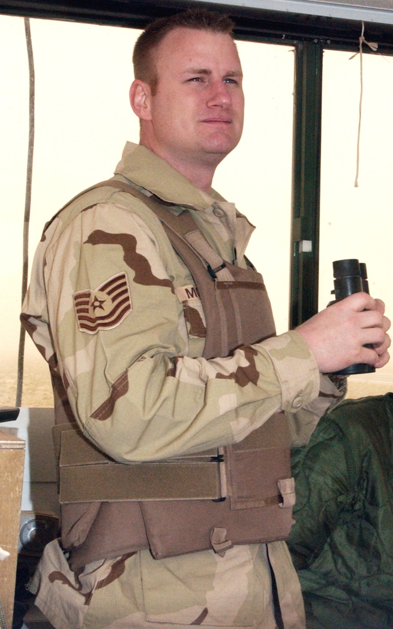 OPERATION IRAQI FREEDOM -- Tech. Sgt. Mark Morrison scans the airfield at a forward-deployed location.  He is an air traffic controller with the 332nd Expeditionary Operations Support Squadron and is deployed from the 46th Operations Support Squadron at Eglin Air Force Base, Fla.  (U.S. Air Force Photo by Master Sgt. Stefan Alford)