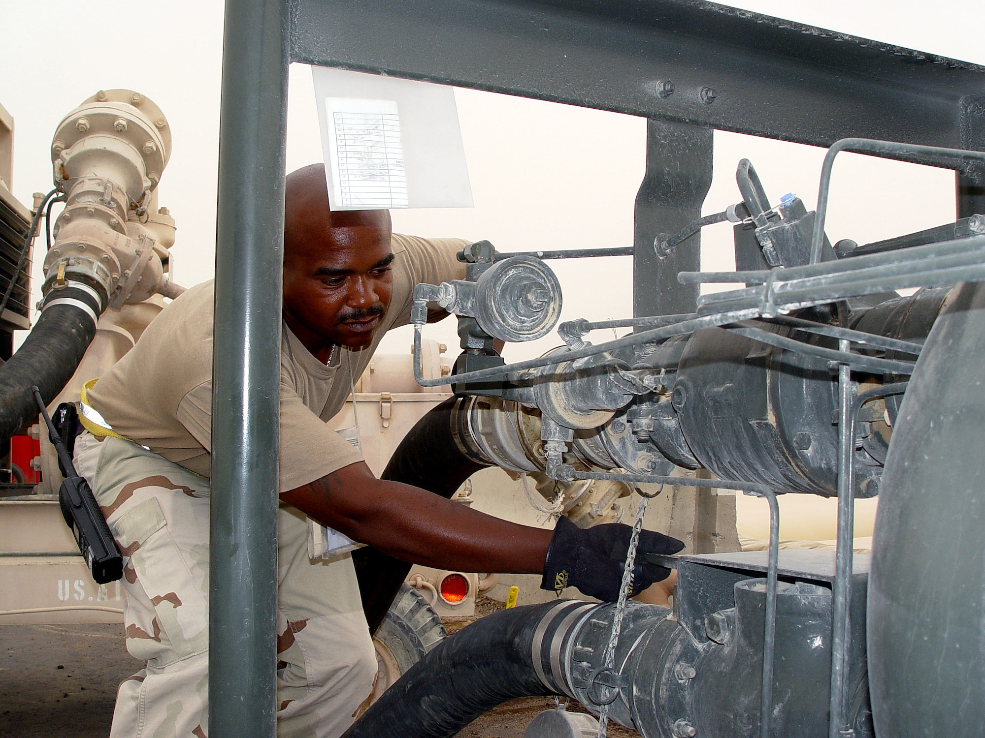 OPERATION IRAQI FREEDOM -- Tech. Sgt. George Anderson, 380th Expeditionary Logistics Readiness Squadron petroluem, oil and lubricants supervisor,  refuels a coalition aircraft from a fuel bladder at a forward deployed location.  Anderson is deployed from Seymour Johnson Air Force Base, N.C. (U.S. Air Force photo by 2nd Lt. Nancy Kuck)